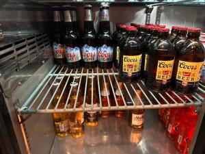 CONTENTS OF BAR COOLERS. - ASSORTED BOTTLES OF BEER AND MIX DRINKS.