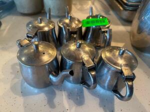 (6) STAINLESS CREAMER DECANTERS.