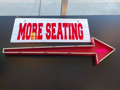 MORE SEATING SIGN AND METAL ARROW.