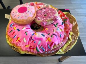 (2) DONUT COSTUMES AND SEVERAL INFLATABLE DONUTS.